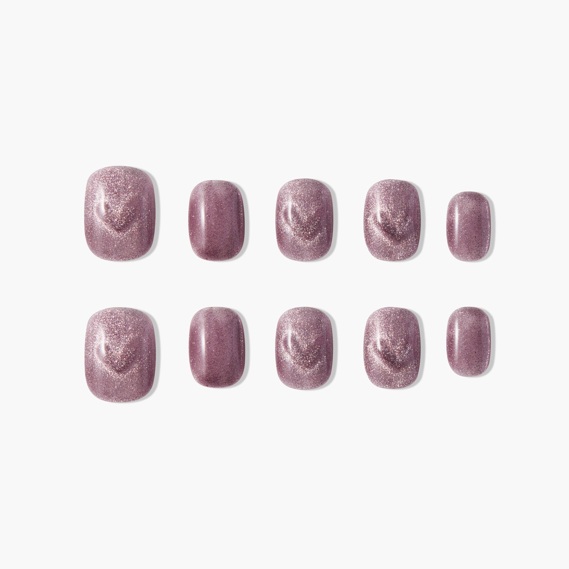 Short square press-on nails with shimmery mauve purple finish, arranged on white background.