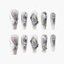 Handmade press-on nails with butterfly design, silver 3D gems, and iridescent accents