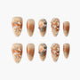 Handmade press-on nails with peach marble, floral 3D accents, rhinestones, and pearl details