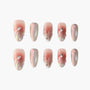 Iridescent pink press-on nails with pearl and rhinestone accents, seashell-inspired design