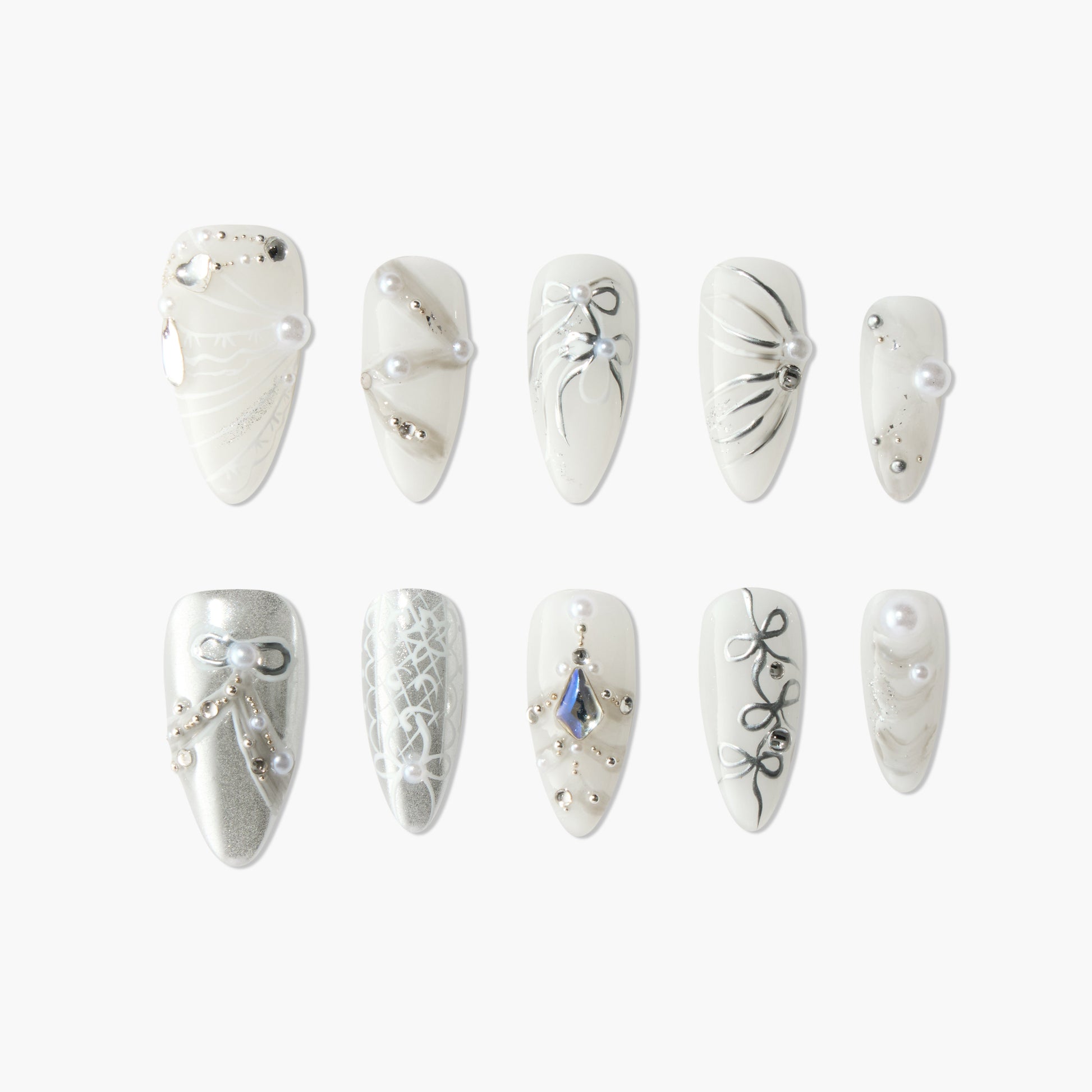 Set of white and silver decorative artificial nails with pearl and rhinestone accents, intricate designs