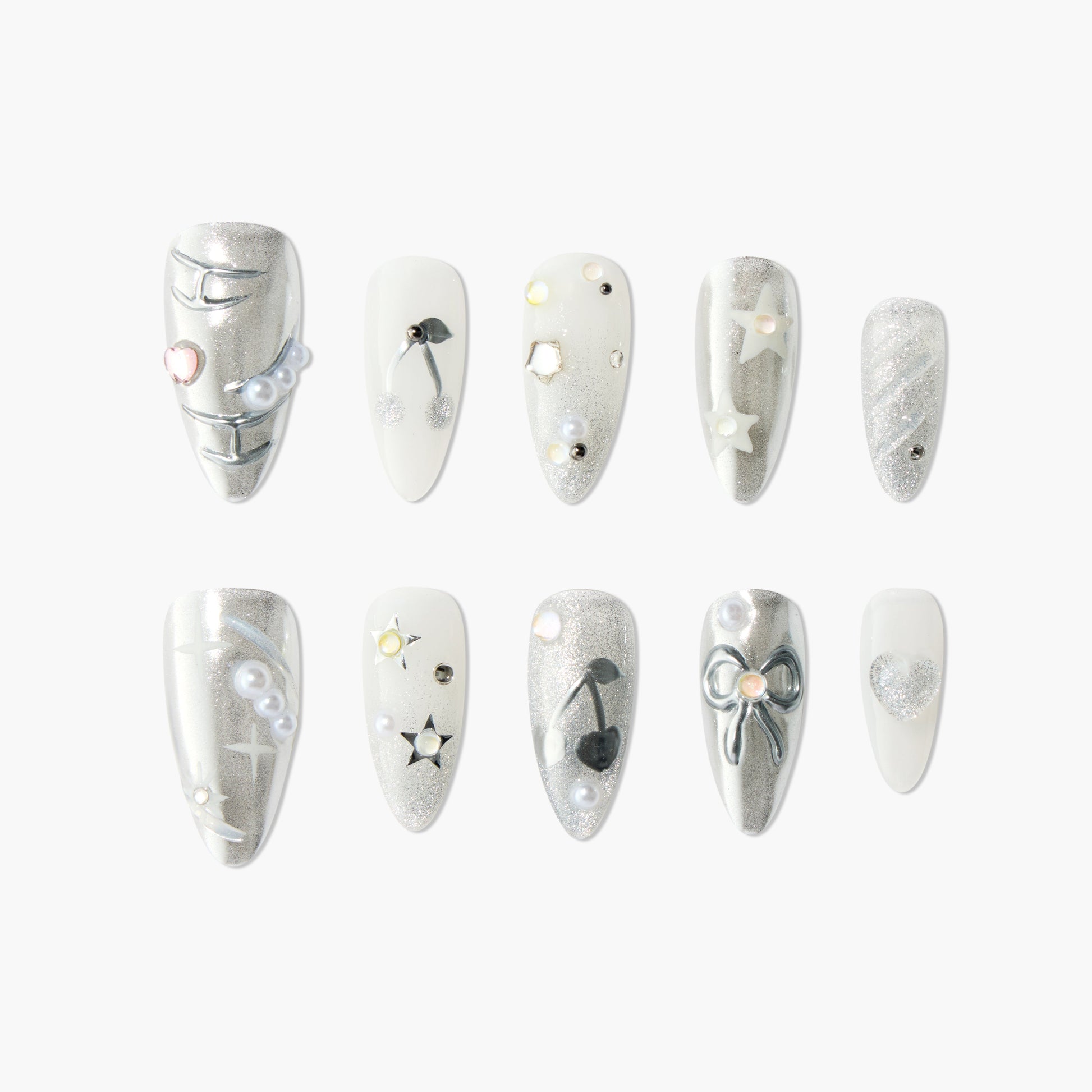 Silver and white press-on nails with glitter, stars, bows, pearls, and heart accents