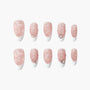 Set of pink glitter press-on nails with white tips and rhinestone accents on a white background.