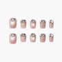 Set of 10 shimmering nude pink press-on nails with clear teardrop rhinestone accents