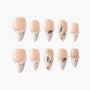Elegant nude and cream false nails embellished with pearls and rhinestone gems in various sizes