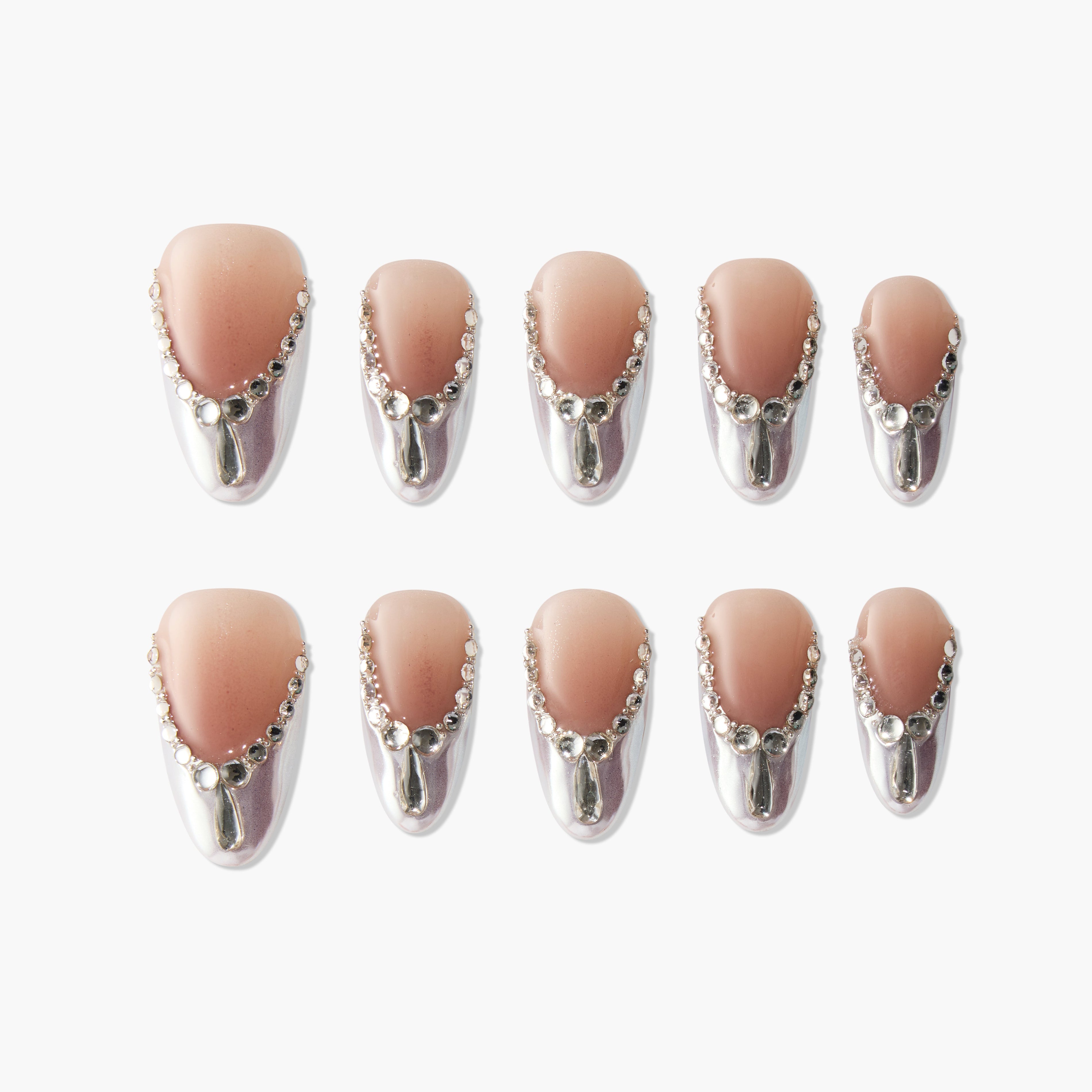 Set of ten nude and silver gradient press-on nails with rhinestone accents on white background