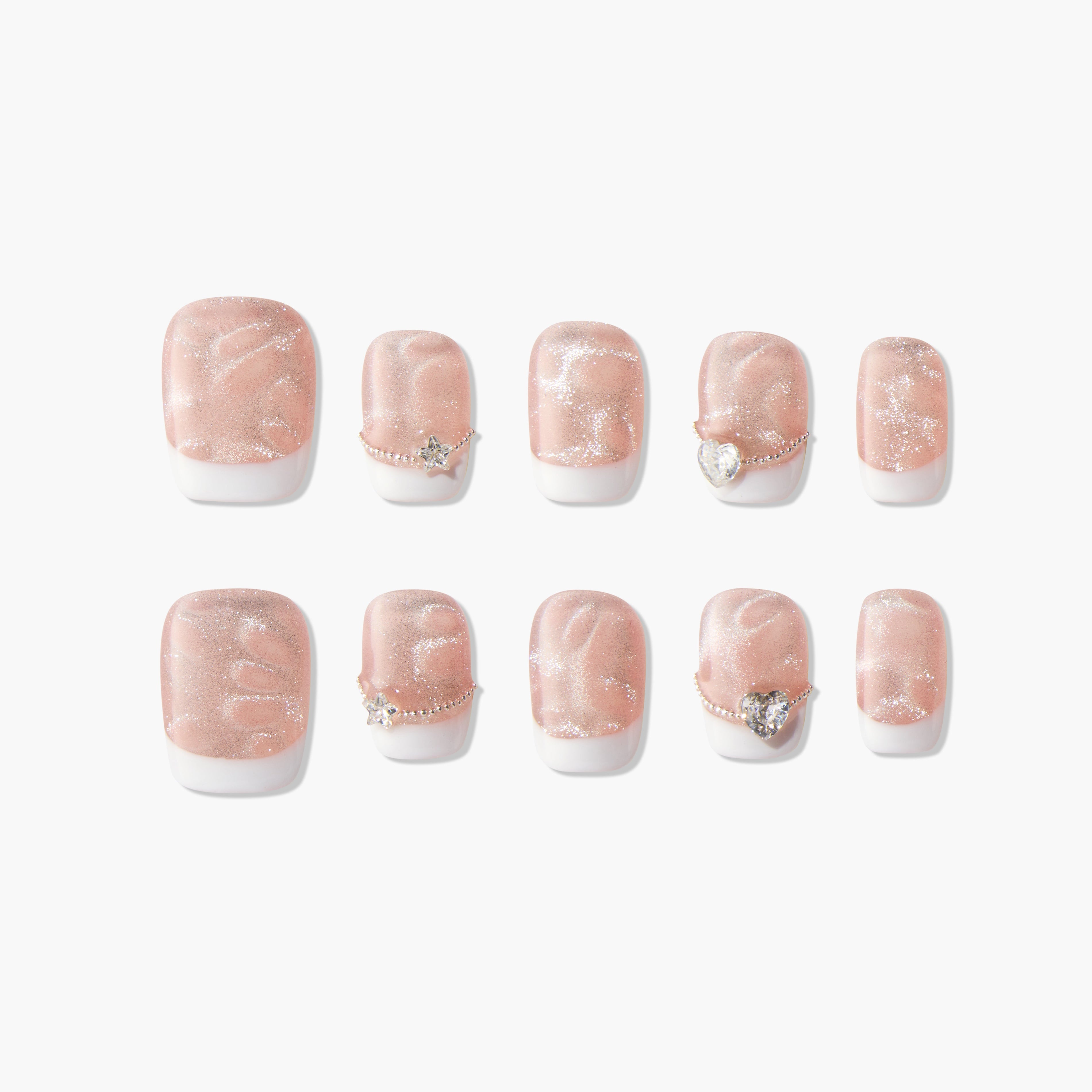 Set of 10 glittery nude and white press-on nails with star and heart rhinestone accents