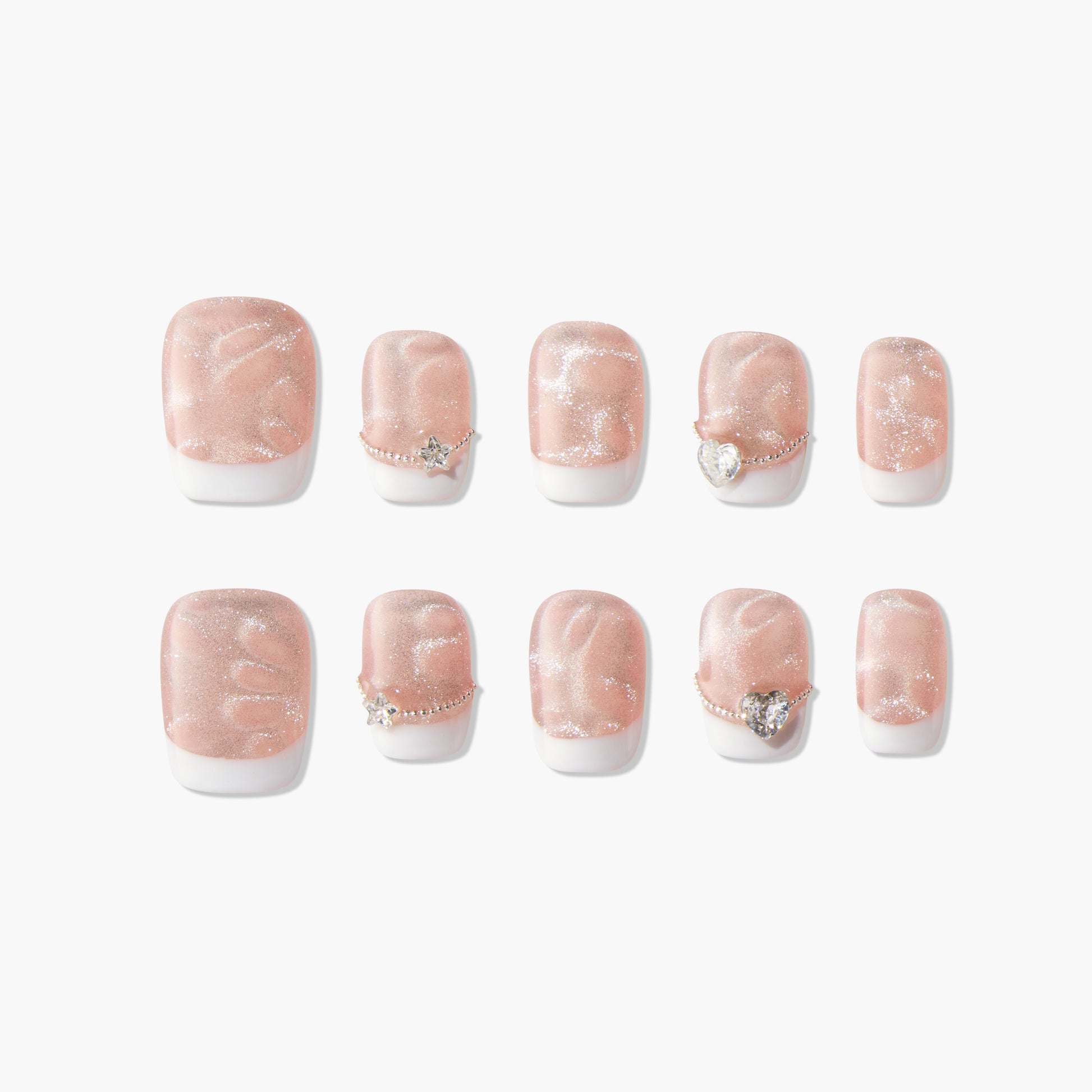 Set of 10 glittery nude and white press-on nails with star and heart rhinestone accents