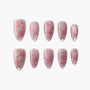 Set of pink glitter press-on nails with hand-painted rose and leaf designs and rhinestone accents