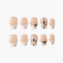 Handmade press-on nails with nude base, pearl accents, and black gemstone embellishments