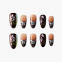 Handmade press-on nails with black base, floral designs, and sparkling accents, arranged on white background.