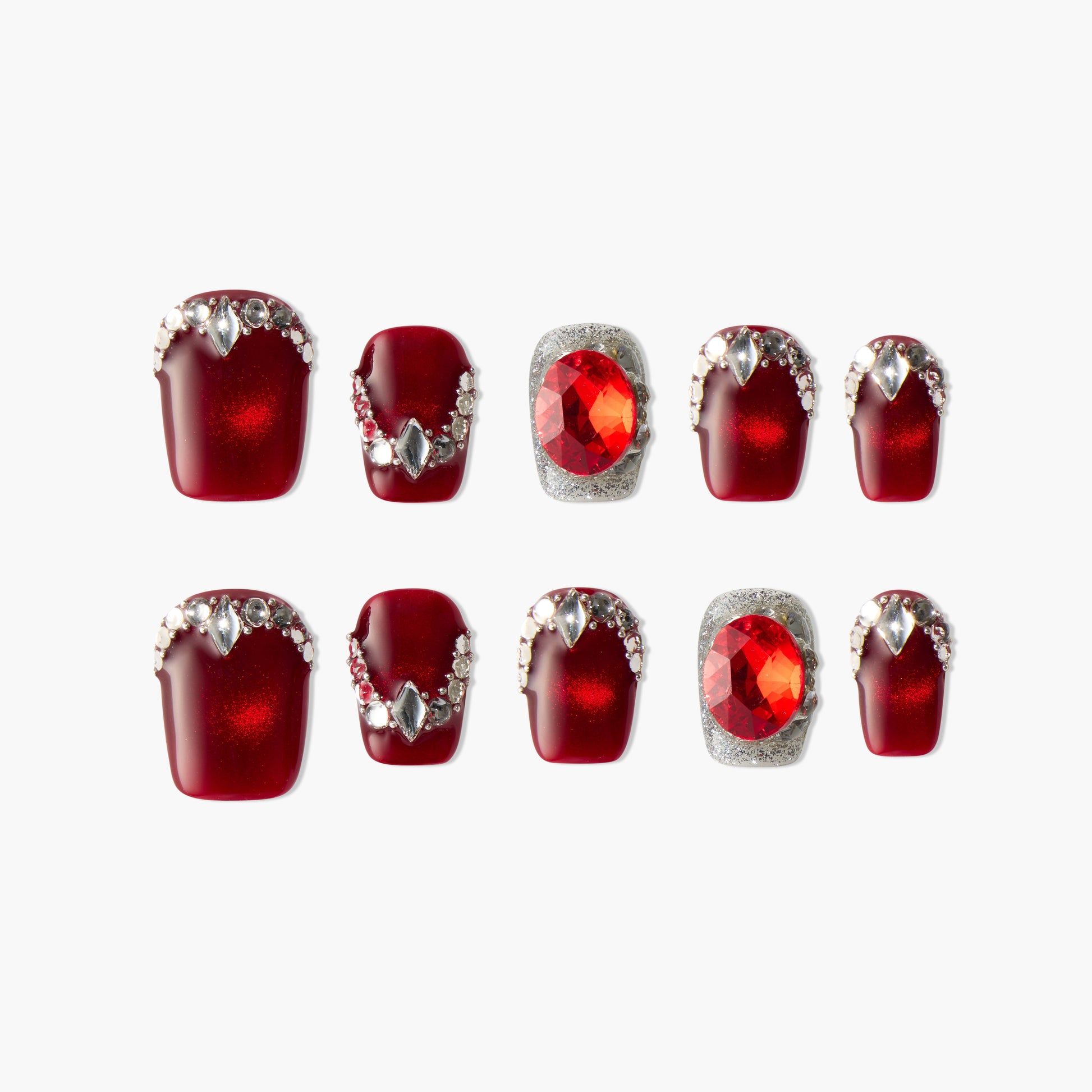 Handmade burgundy press-on nails with silver rhinestones and large red gem accents