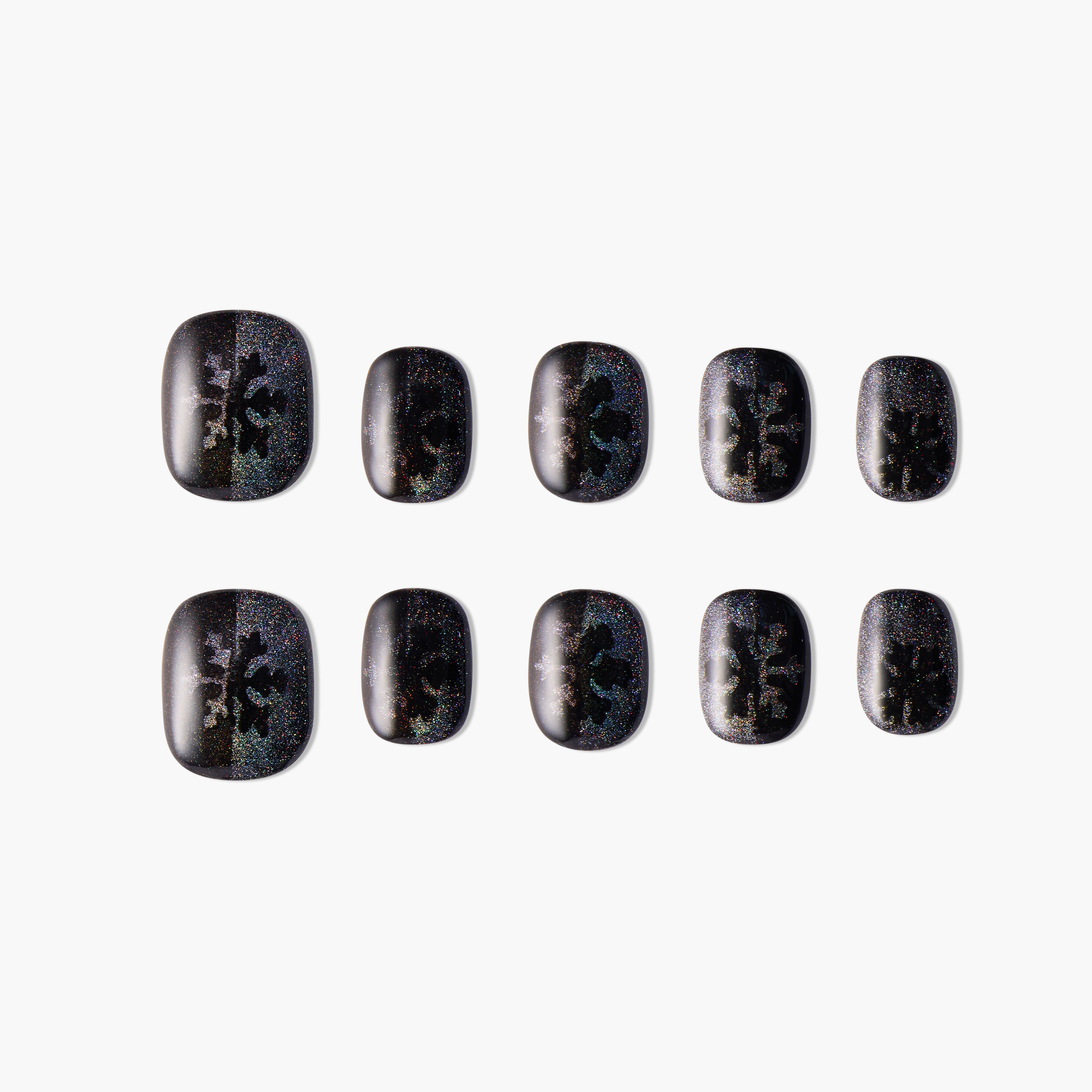 Set of black glittery press-on nails with subtle snowflake design, arranged on white background