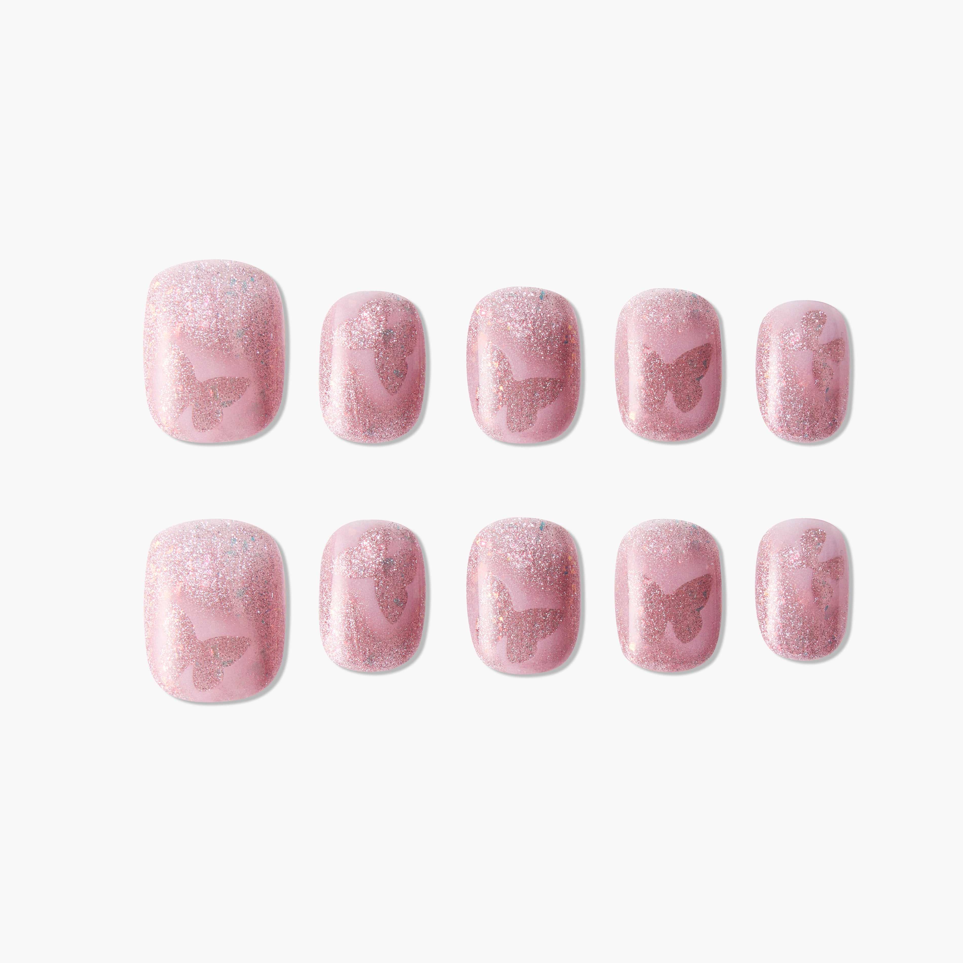 Set of pink glittery press-on nails with subtle butterfly designs, arranged on white background