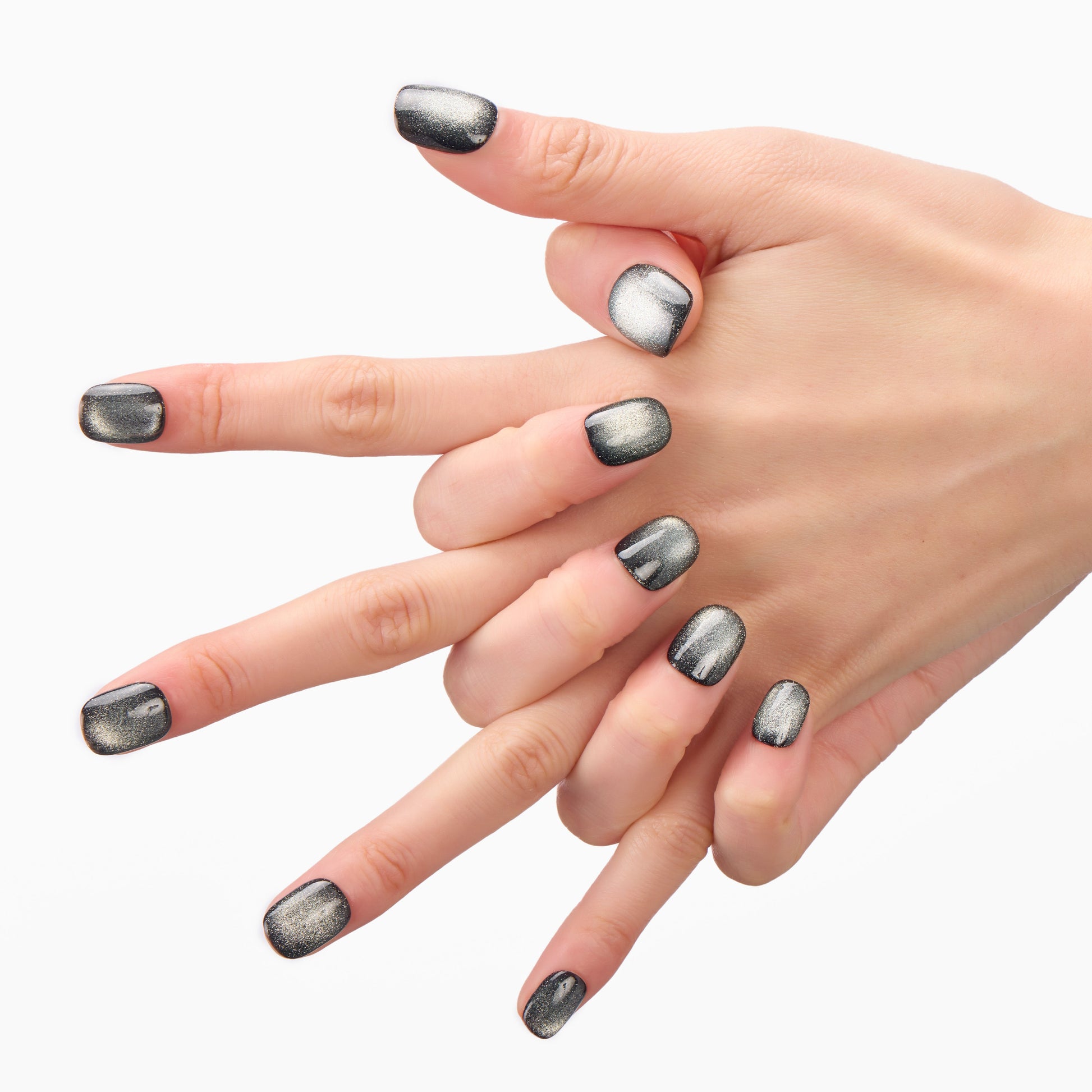 Hand with metallic black press-on nails, square shape, on a white background.