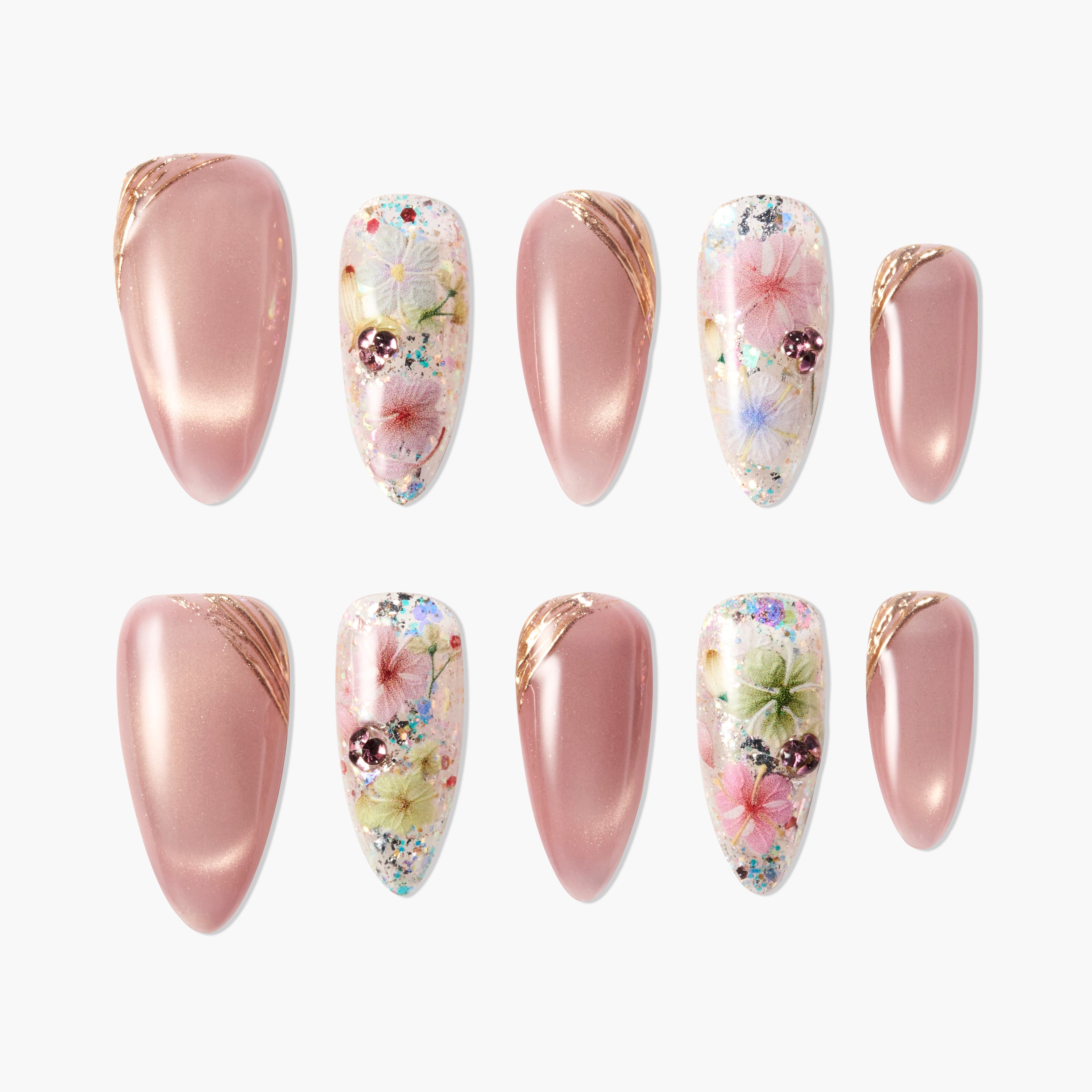 Set of pink and floral glitter press-on nails with gold accents on white background