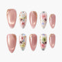 Handmade press-on nails in pink and floral designs with gold accents and glitter details