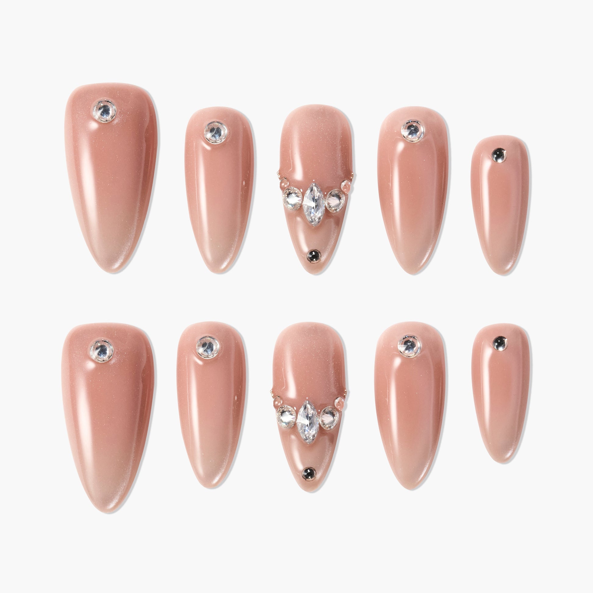 Set of nude beige glossy press-on nails with rhinestone accents in various sizes