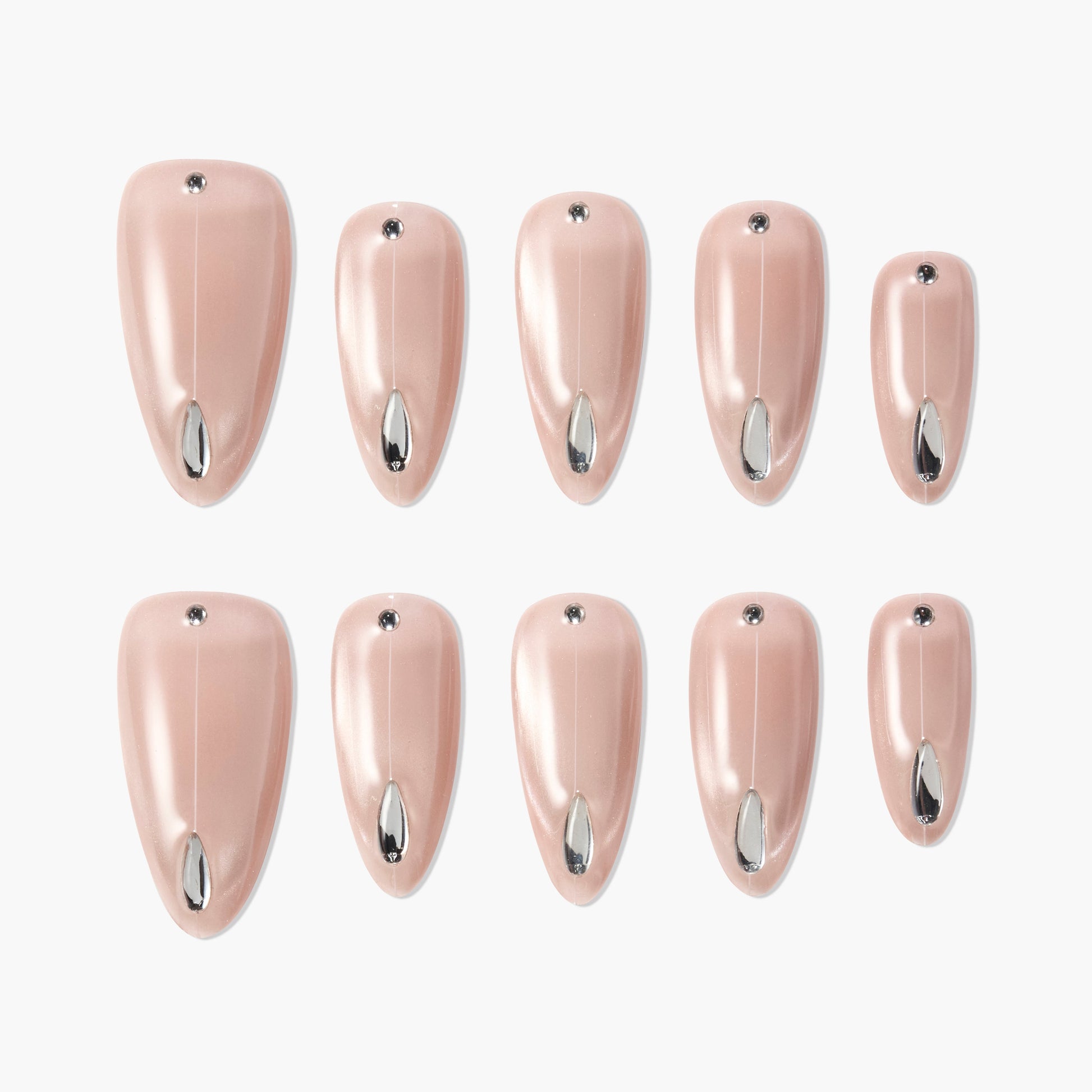 Set of nude pink press-on nails with silver teardrop and rhinestone accents on white background