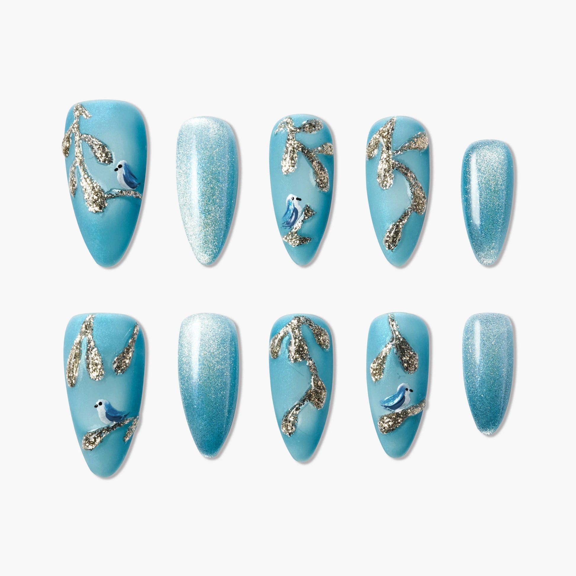 Blue press-on nails with glittery gold branches and small blue bird designs, plus sparkly gradient nails