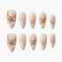 Set of glittery nude and gold artificial nails with 3D floral and pearl accents