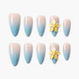 Set of blue and pink ombre press-on nails with yellow 3D flower embellishments