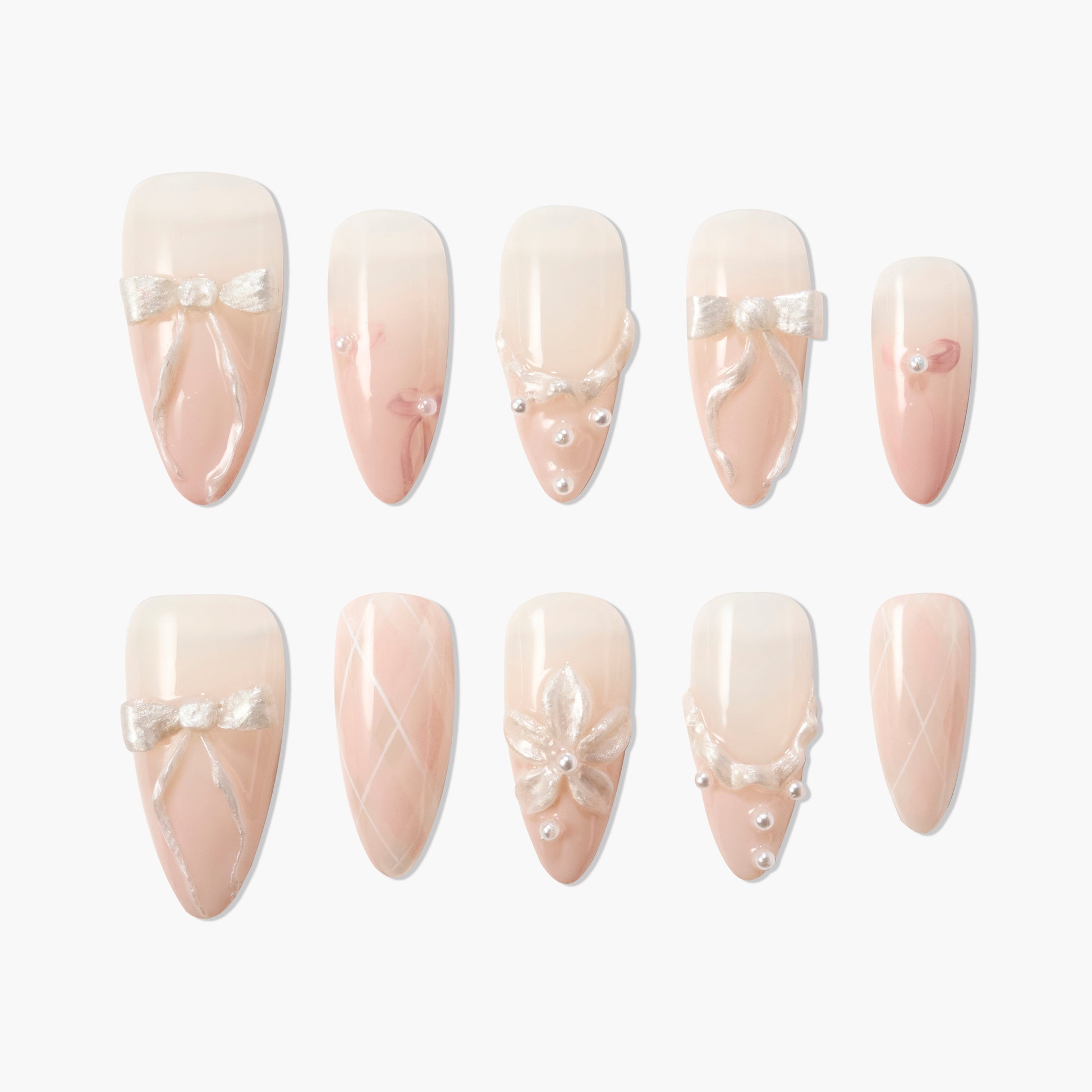 Set of nude and white ombre press-on nails with 3D pearl and bow nail art designs
