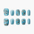 Set of blue press-on nails with glittery gold branches and small blue bird designs