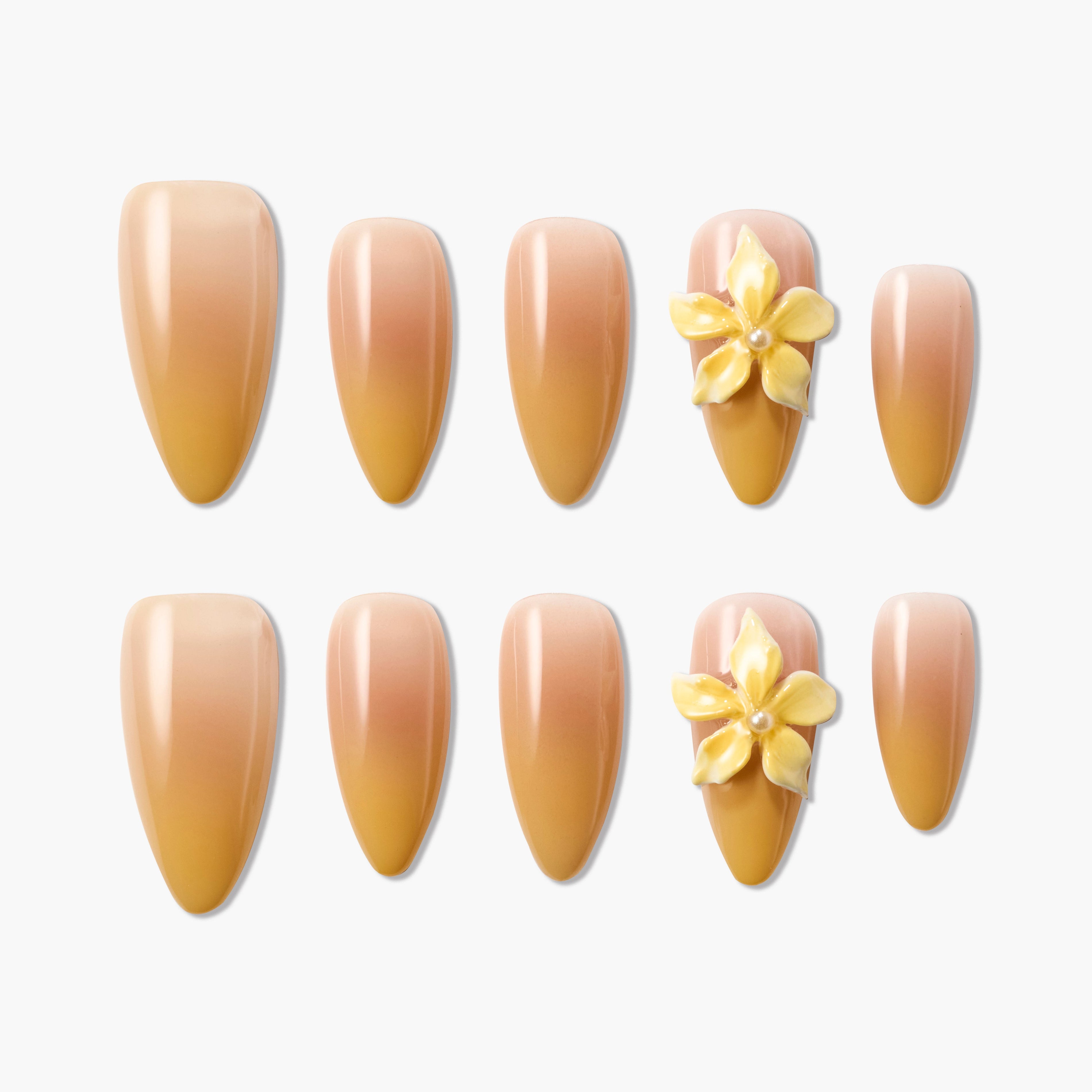 Set of nude ombre press-on nails with yellow 3D flower accents and pearl detail