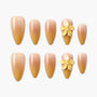 Set of nude ombre press-on nails with yellow 3D flower accents and pearl detail