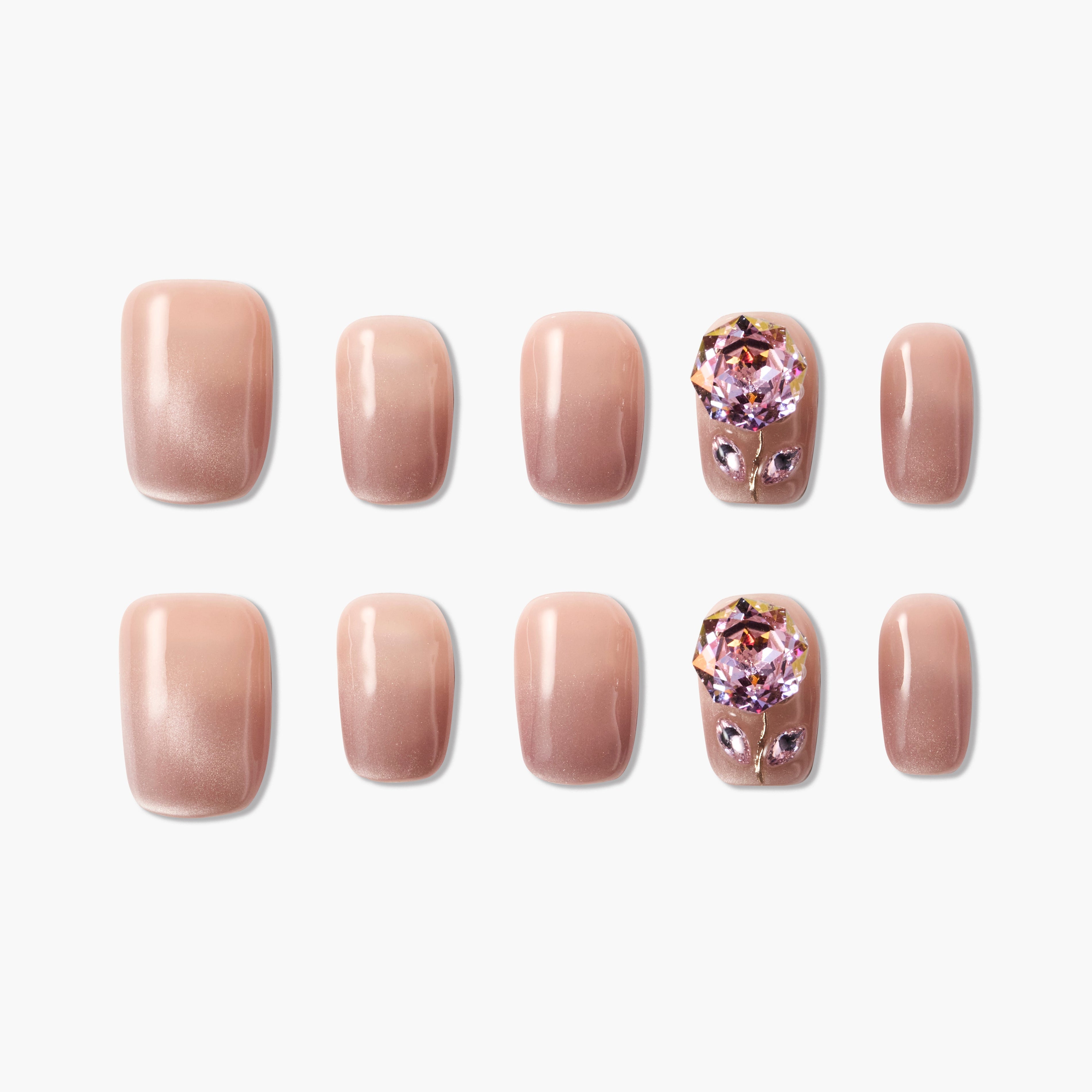 Set of nude gradient press-on nails with two accent nails featuring large pink crystal flower designs