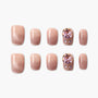 Set of nude gradient press-on nails with two accent nails featuring large pink crystal flower designs