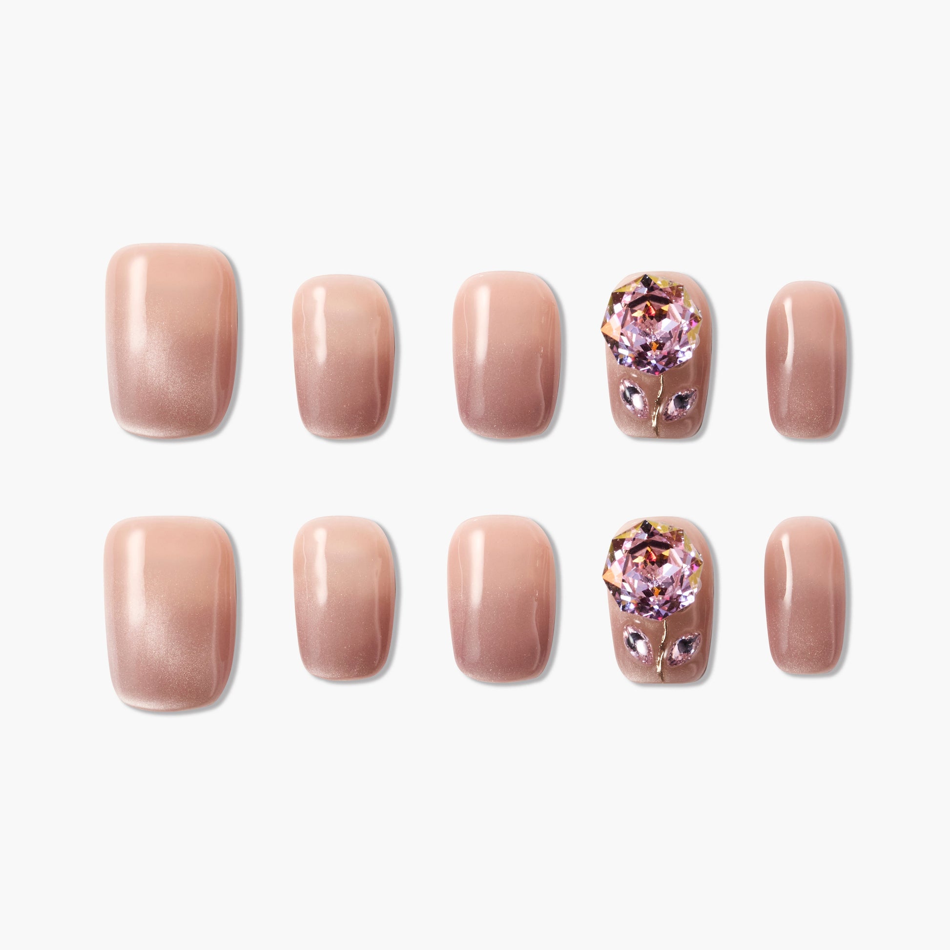 Set of nude gradient press-on nails with two accent nails featuring large pink crystal flower designs
