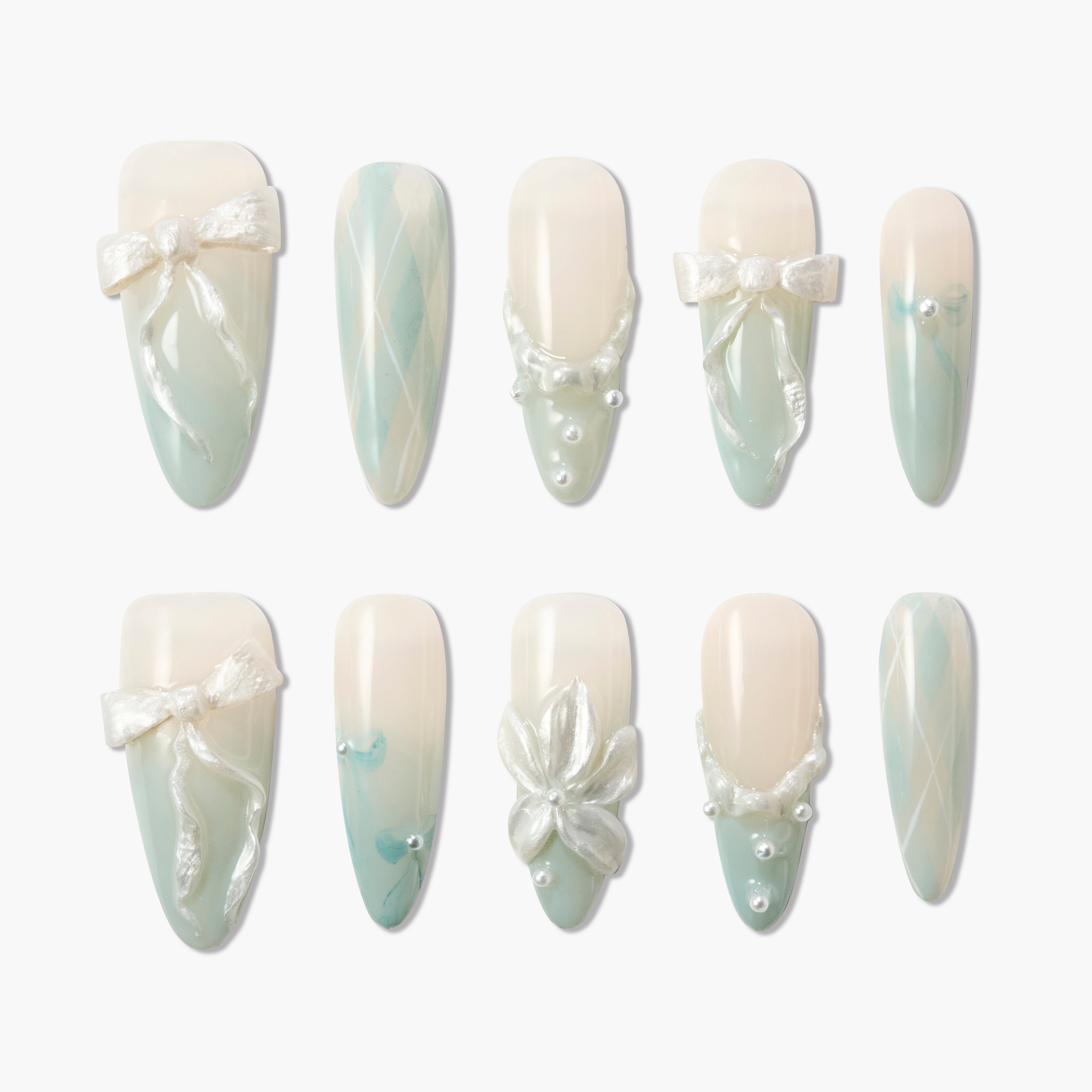 Elegant false nails set with pastel green ombre, pearl accents, 3D bows, flowers, and argyle patterns