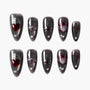 Set of black glossy false nails with red and silver gothic heart and abstract designs