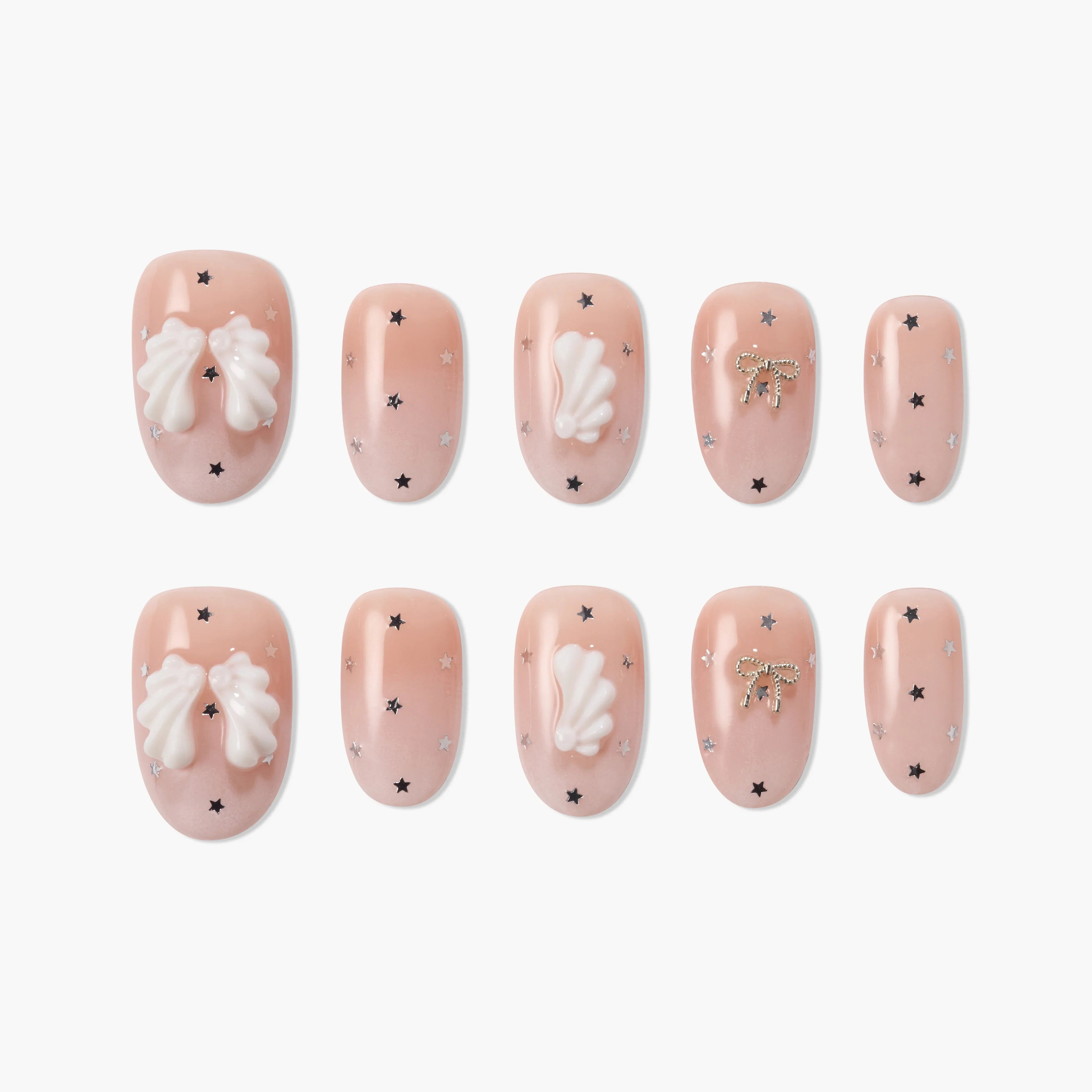 Handmade press-on nails with nude pink base, white 3D bows, gold bow accents, and star details