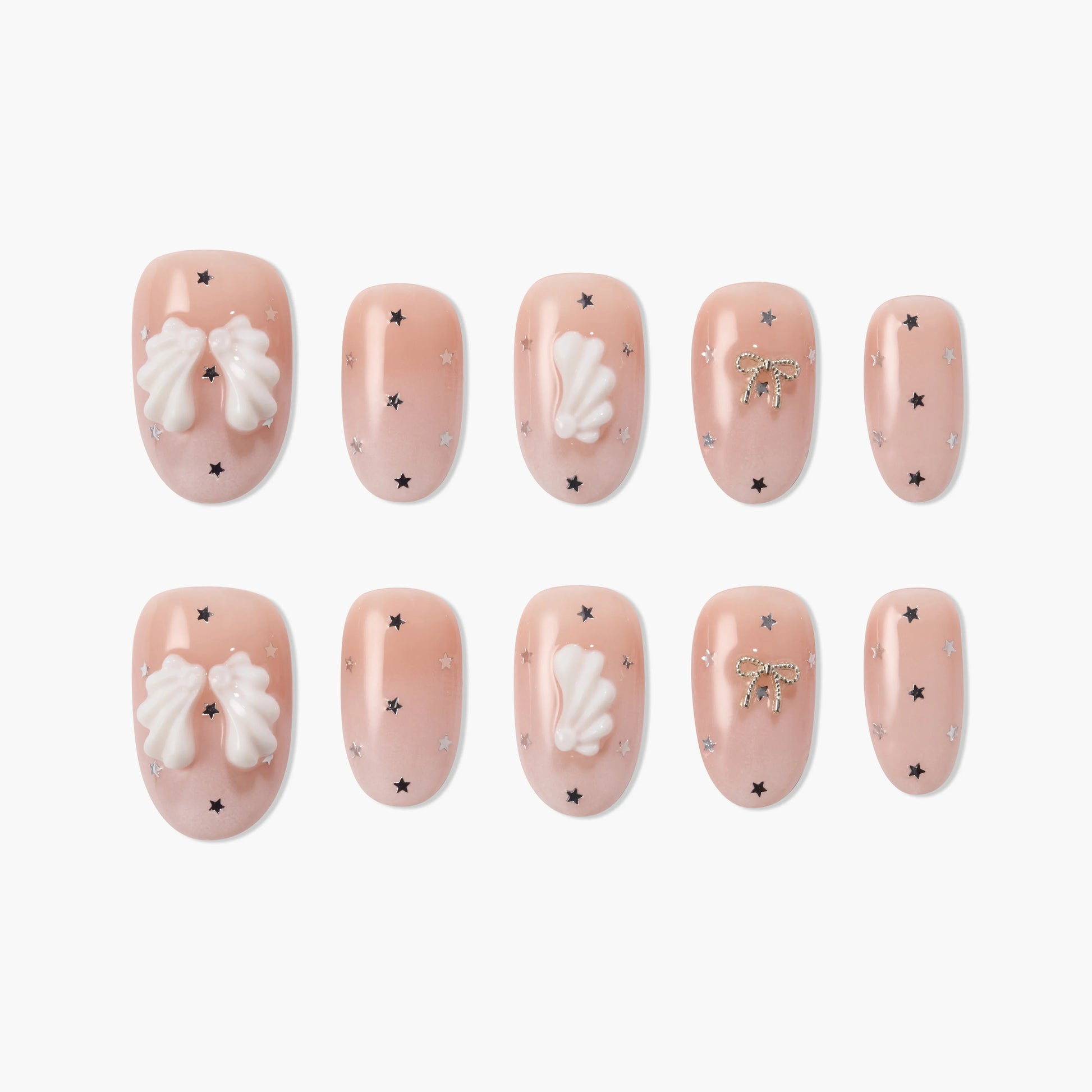 Handmade press-on nails with nude pink base, white 3D bows, gold bow accents, and star details