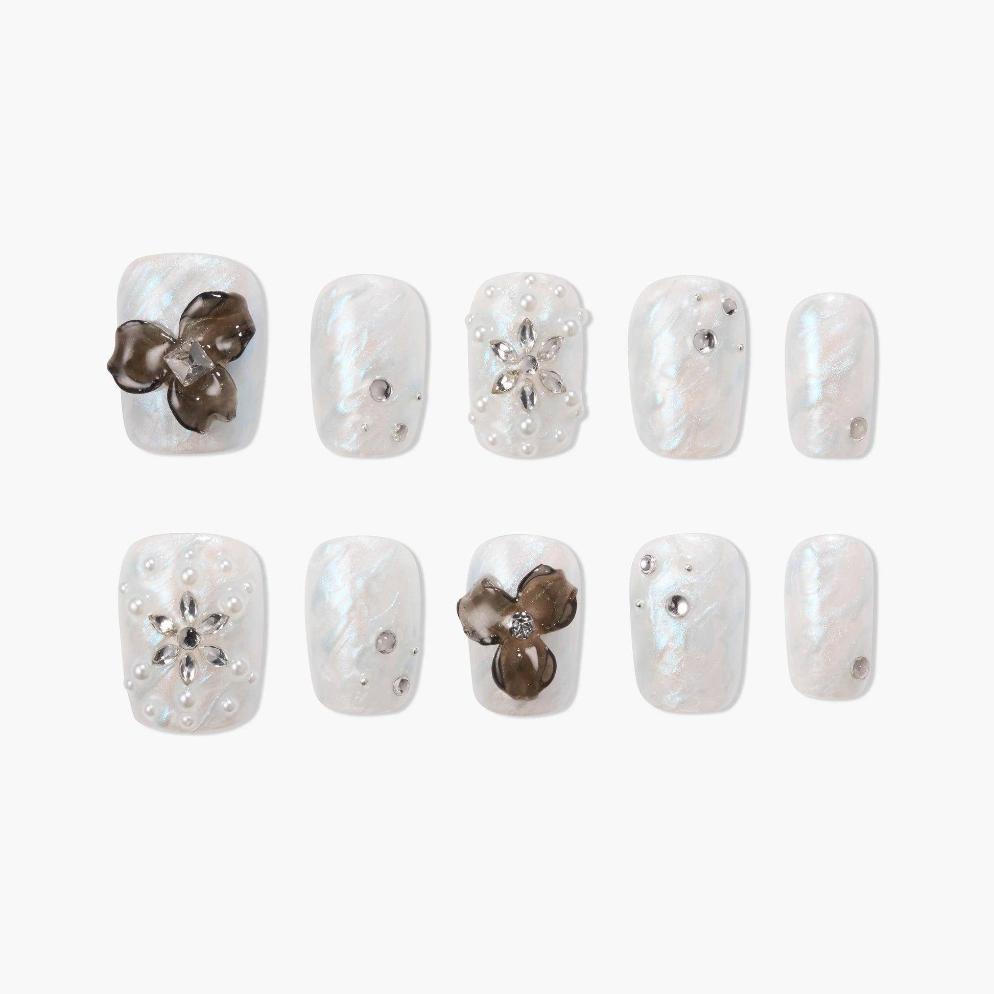 Pearl white press-on nails with 3D flower accents, rhinestones, and pearl details