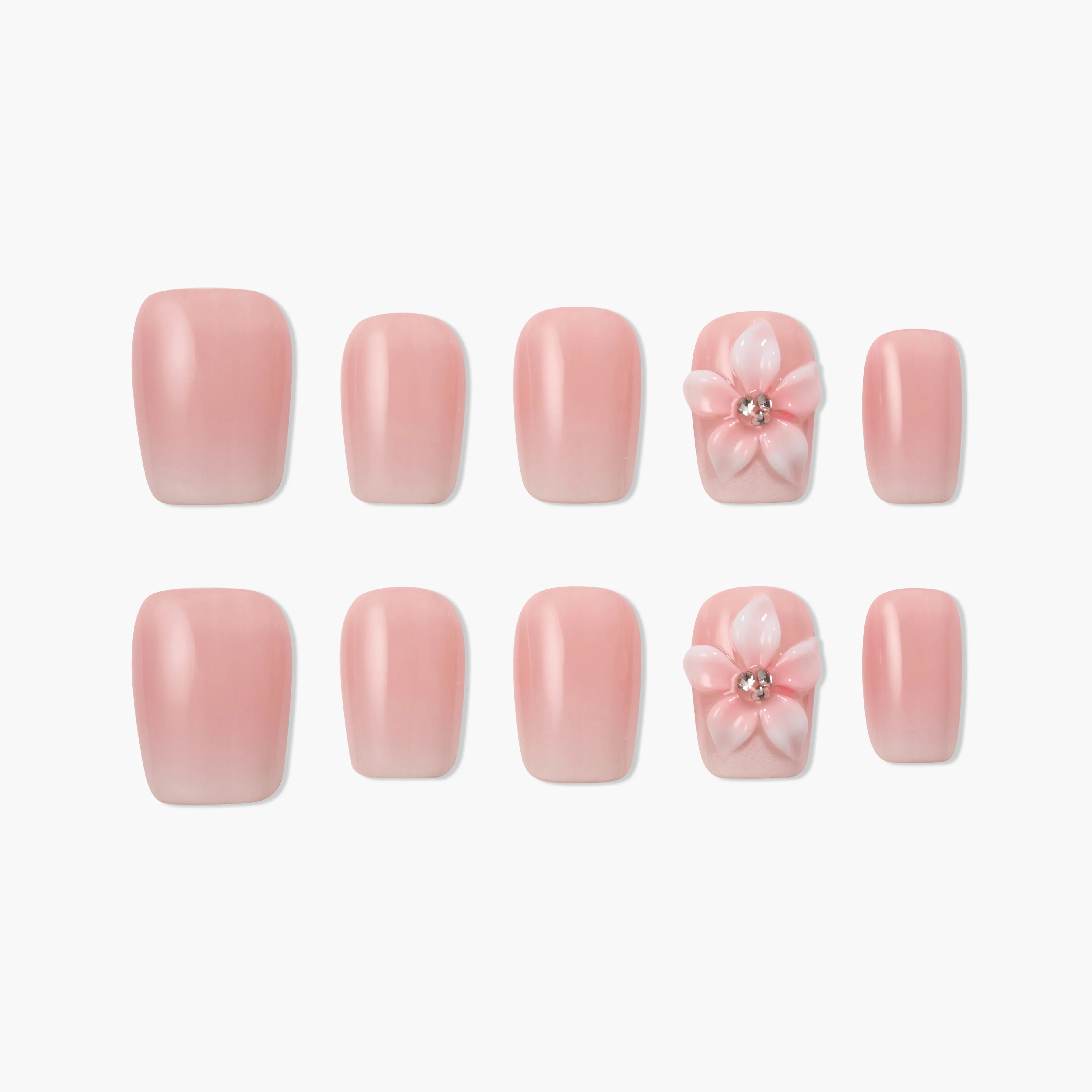 Handmade pink press-on nails with 3D flower and rhinestone accent, arranged on white background