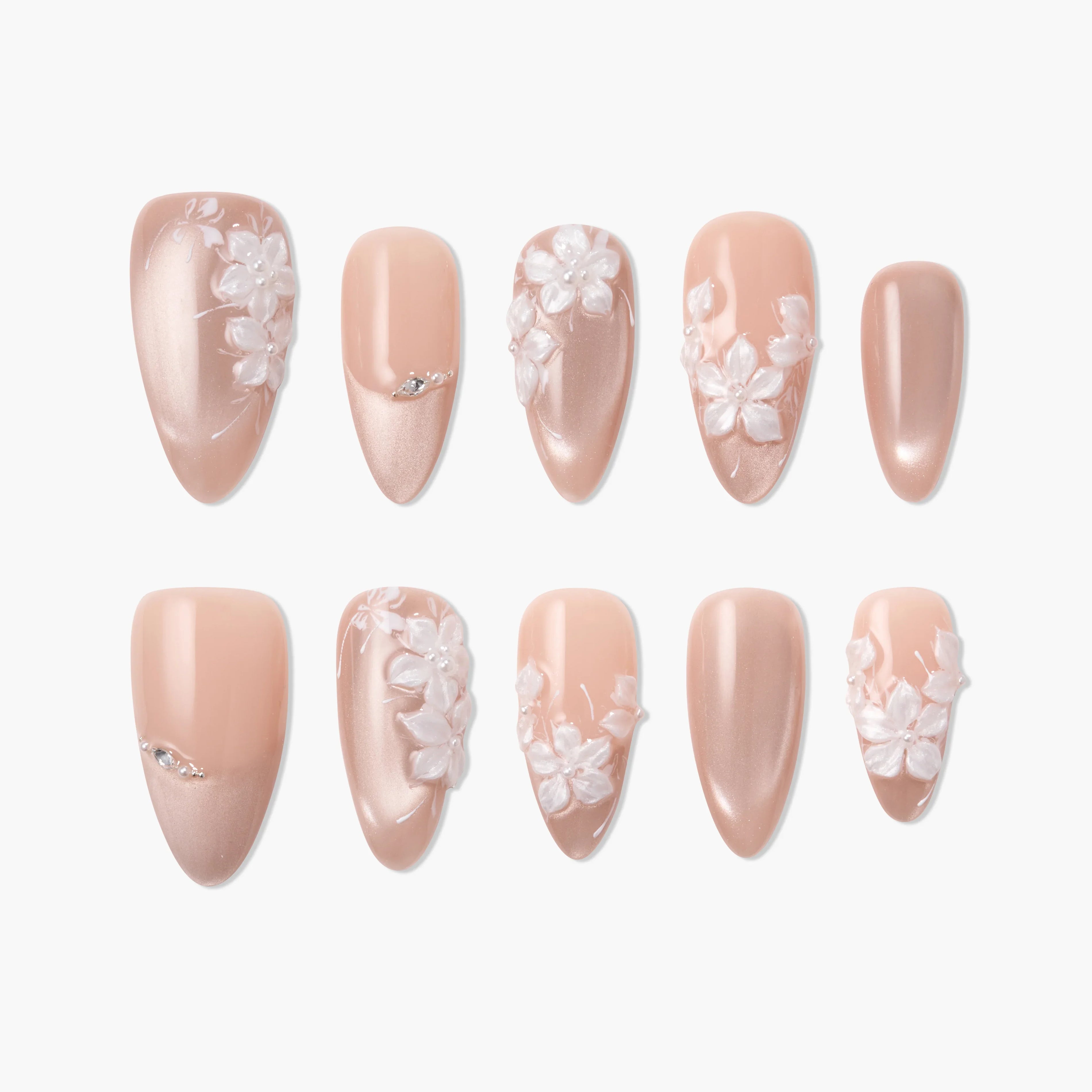Handmade nude press-on nails with 3D white floral designs and subtle rhinestone accents