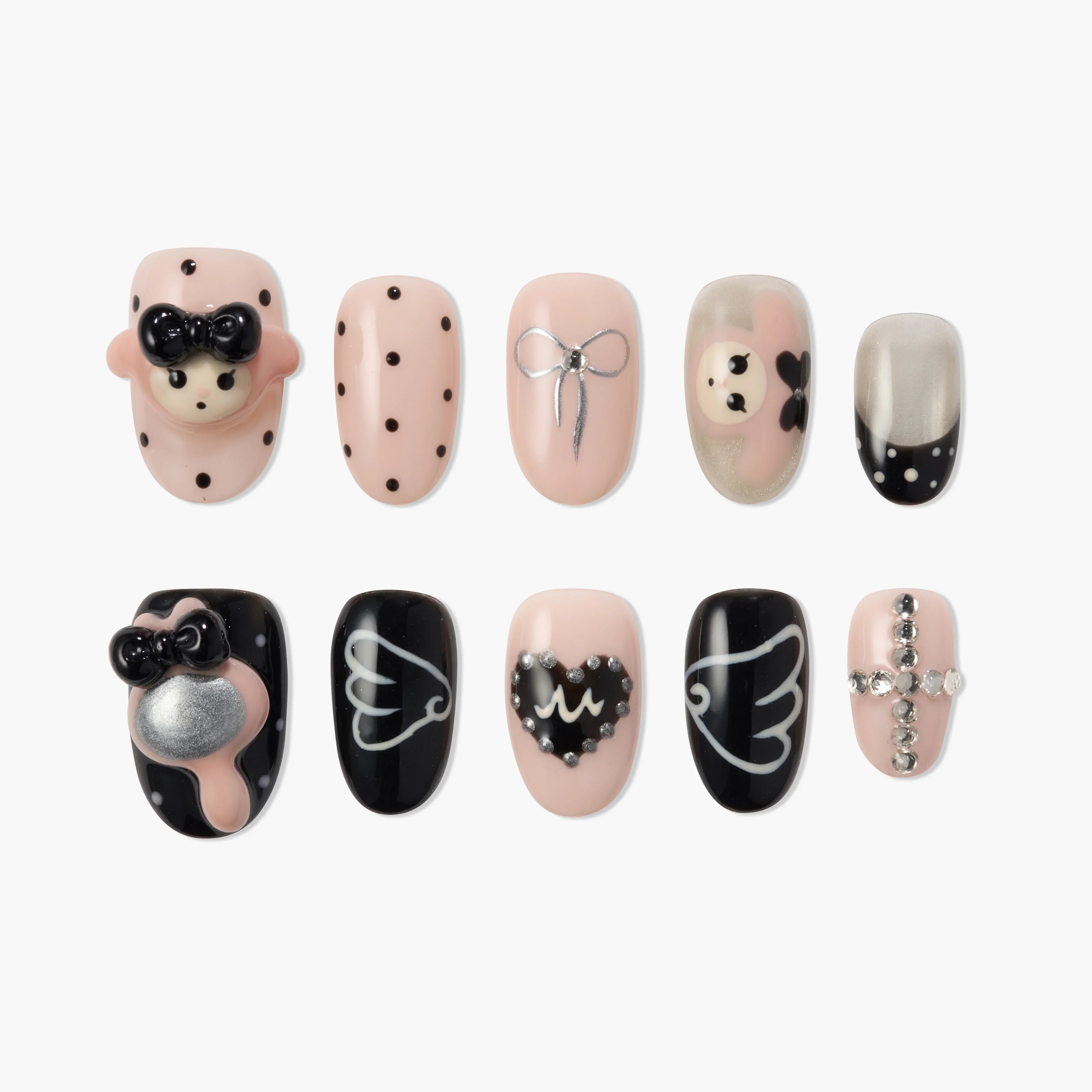 Handmade press-on nails with cute bear, polka dots, bows, hearts, wings, and rhinestone cross designs.
