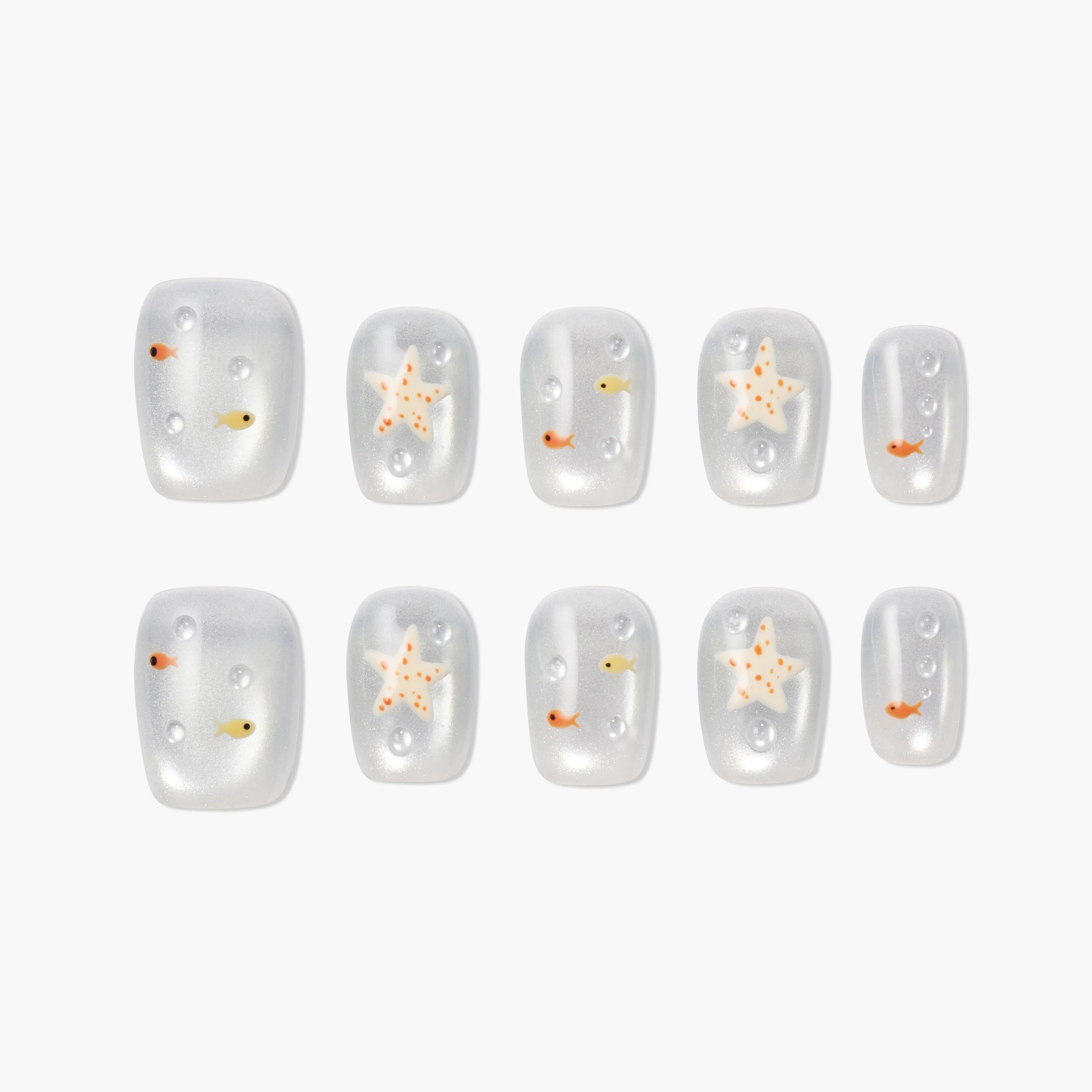 Handmade press-on nails with starfish and fish designs on a pearly white background