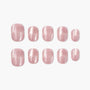 Set of glossy light pink handmade press-on nails in various sizes on a white background