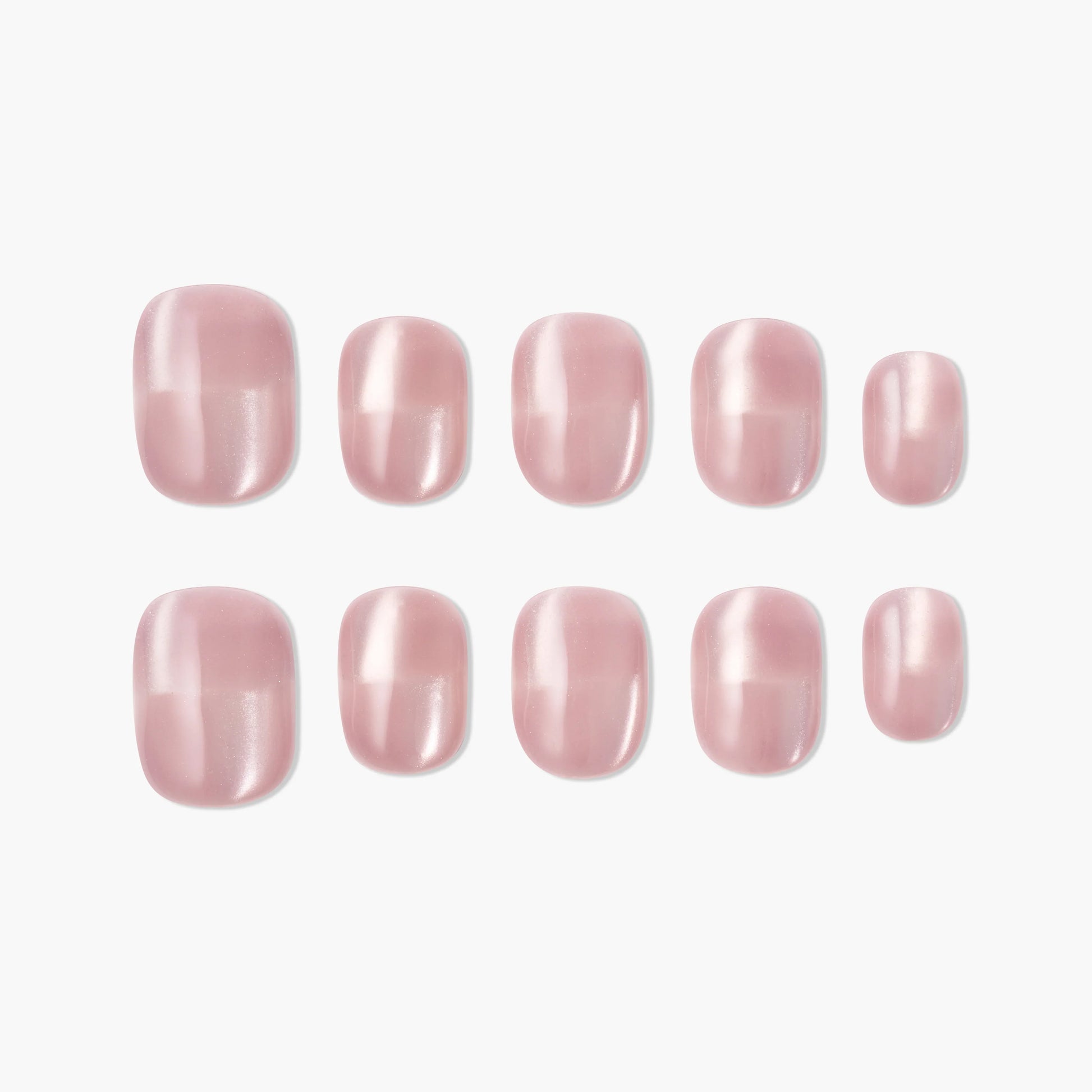 Set of glossy light pink handmade press-on nails in various sizes on a white background