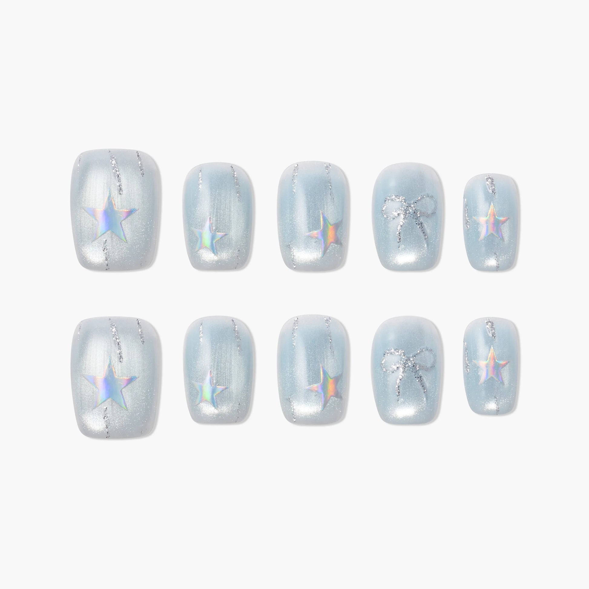Handmade press-on nails with iridescent stars and silver glitter bows on pastel blue background