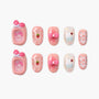 Cute pink press-on nails with cartoon, strawberry, cupcake, bow, and lace-up designs