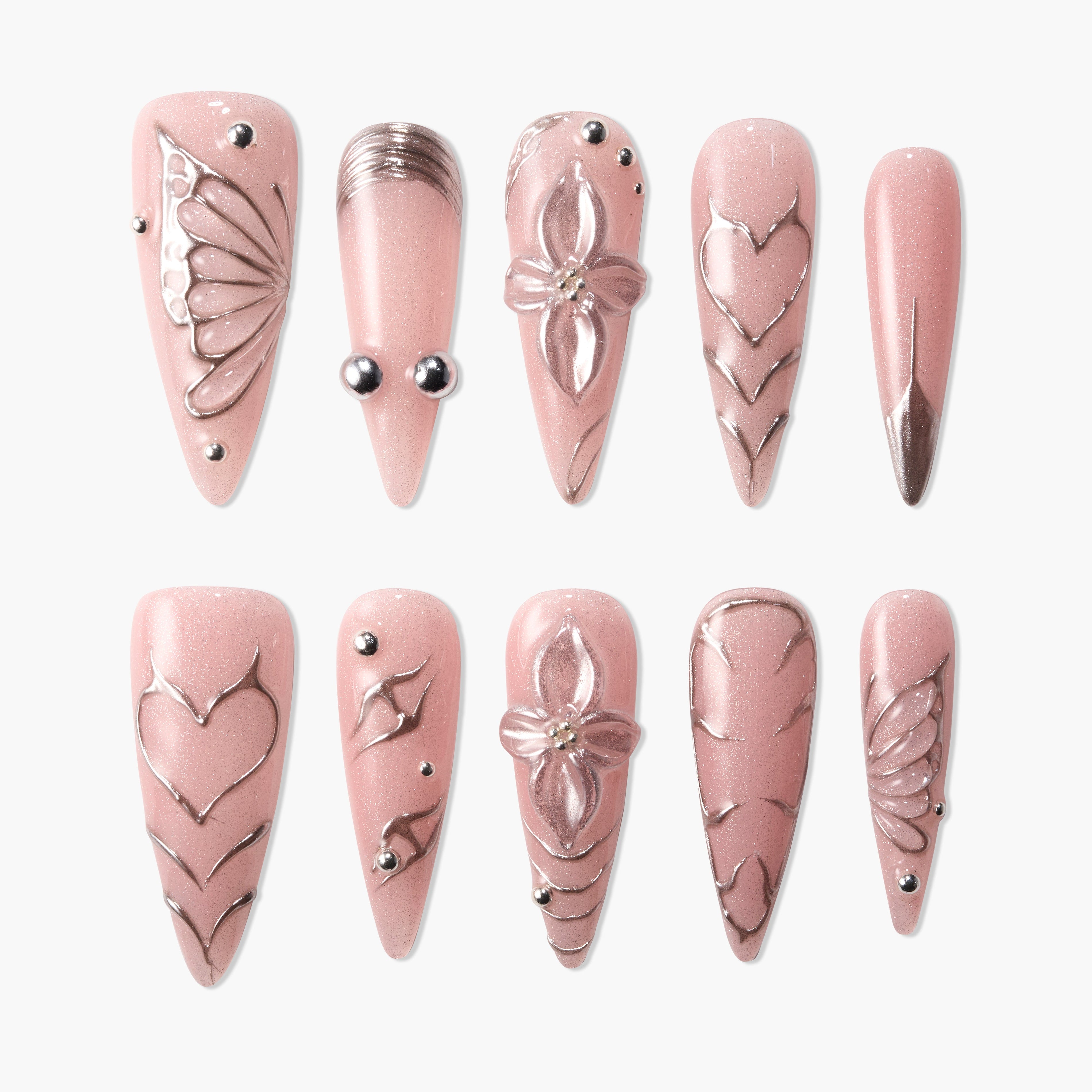 Set of pink glitter press-on nails with silver accents, floral and heart designs, and rhinestone details