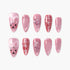 Set of pink press-on nails with glitter, heart and moon embellishments, grid patterns, and cute bear faces