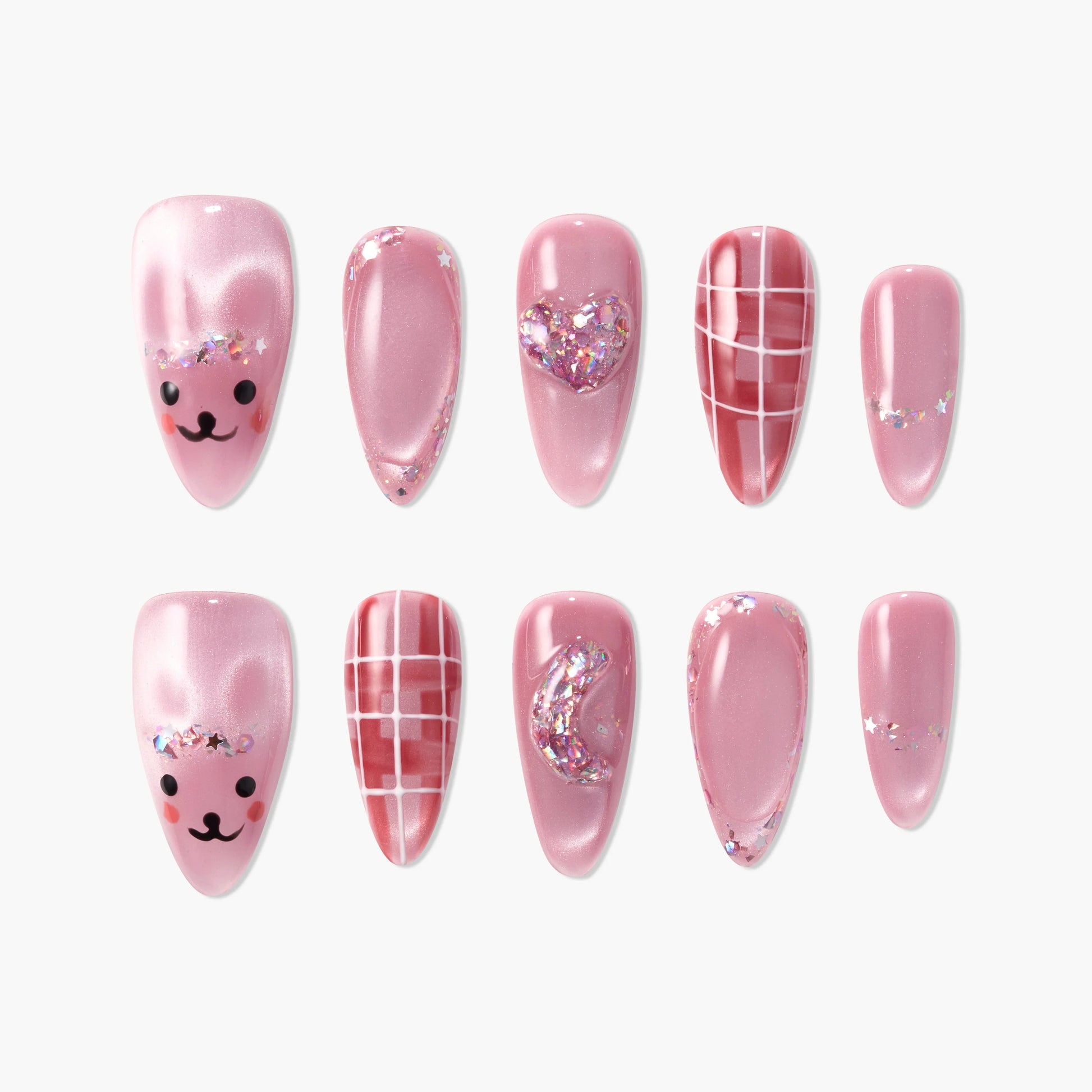 Set of pink press-on nails with glitter, heart and moon embellishments, grid patterns, and cute bear faces