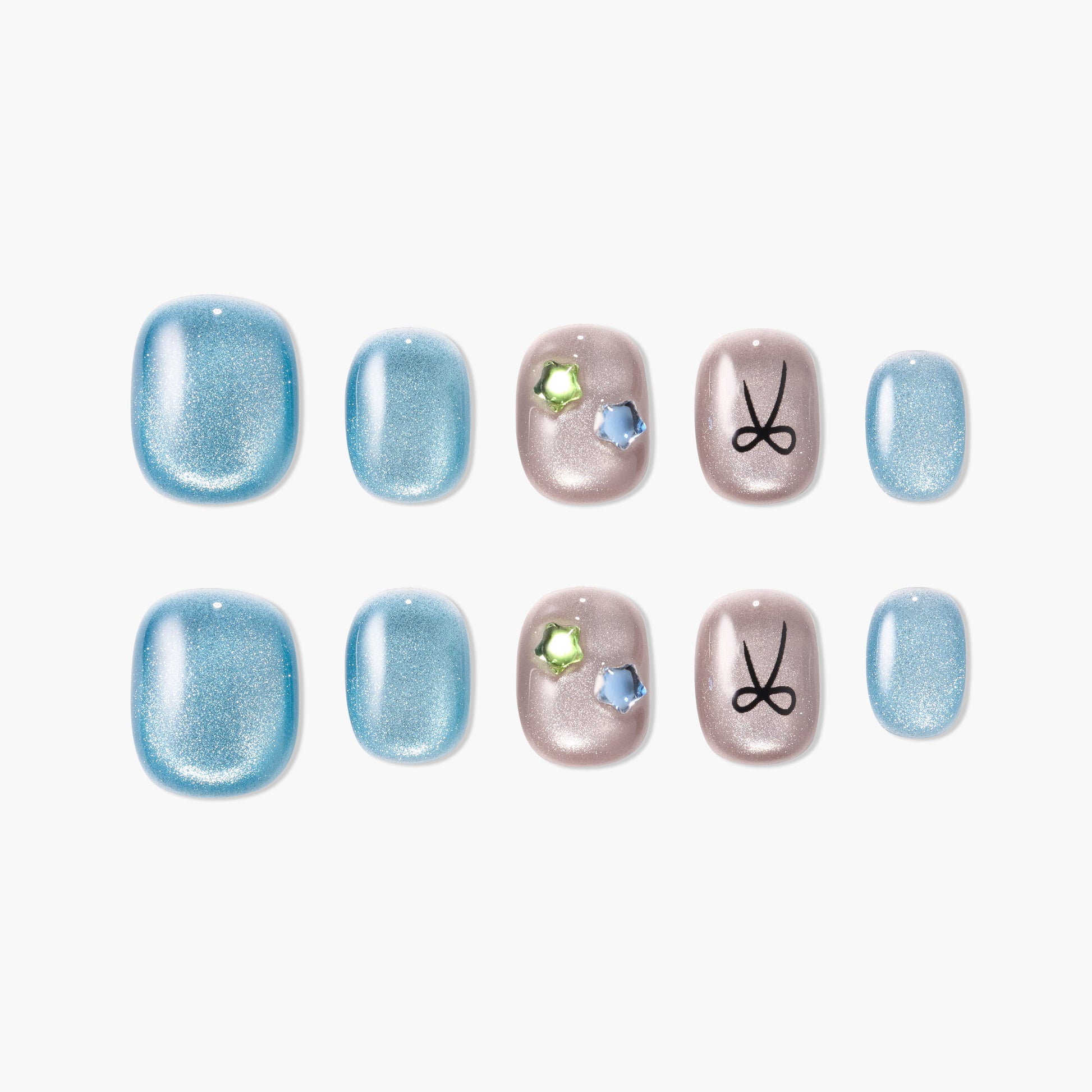 Set of glittery blue and beige press-on nails with star-shaped gems and black scissors design